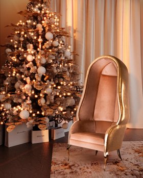 Christmas Season | cosy living room with Drapesse blush pink leather back chair, christmas tree, and gifts