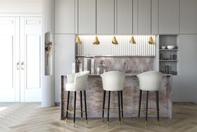 Kitchen | marble kitchen island with Besame curvy white bar stool, Gia gold pendant lamp, Flora sconce wall lamp, shelves for storage, and wood flooring