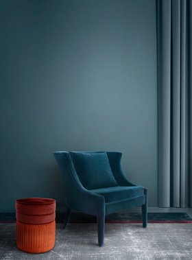 Living Room | teal paint reading corner with Athina curvy blue chair, Sophia cosy brown and orange stool, and cushion