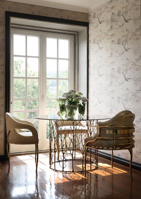 Dining Room | spring/summer decor in nature inspired style with Enchanted glass dining table, Chandra curvy gold dining chair, vase, wood flooring, and wallpaper