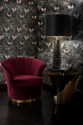 Living Room | dark paint reading corner with Besame curvy deep red armchair, Yasmine gold side table, Ruchê table lamp, and nature inspired wallpaper