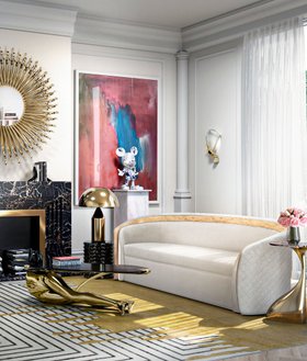 Living Room | spring/summer decor in quiet luxury style with Sultana curvy white sofa, Tabu glass center table, Valencia yellow striped rug, Muse sconce, gold table lamp, stove, and wall art