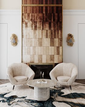 Living Room | spring/summer reading corner in cosy elegant style with Audrey curvy white armchair, Hypnotic gold sconce, marble center table, blue round rug, stove, and wood wall panel