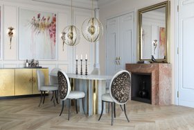Dining Room | spring/summer dining area in art deco style with Merveille animal print dining chair, Paris white marble dining table, Roxy gold chandelier, Heive cabinet for storage, Flora sconce, wall mirror, stove, candles, and wood flooring