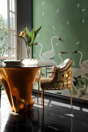 Dining Room | cosy elegant dining area in luxury modern style with Yasmine gold and glass dining table, Asia dining chair, mint green animal print wallpaper, vase, and dark wood flooring