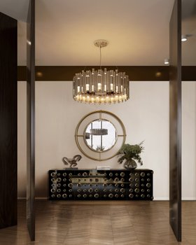Entryway | autumn/winter hallway in retro style with Shirley gold wall mirror, Monocles dark metal sideboard for storage, Brubeck gold chandelier, vase, and brown wood flooring