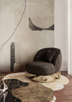 Living Room | cosy elegant reading corner in dark and gold tones with Angra armchair, Ophelia marble center table, Fortuna rug, and wood flooring