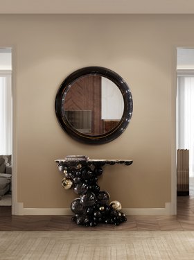 Hallway | beige paint entryway in luxury modern style with Ring dark wall mirror, Newton black and gold console, White Garden neutral rug, and brown wood flooring