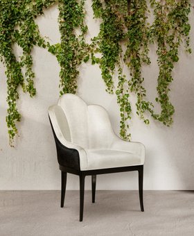 Outdoors | outdoor area with Anastasia curvy black and white dining chair, stone flooring, and some greenery