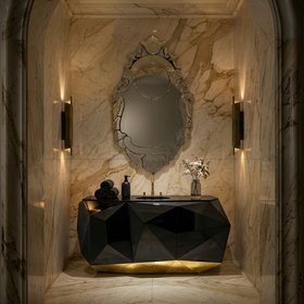 Bathroom | white marble bathroom in modern classic style with Veneto rococo wall mirror, Diamond dark and gold vanity cabinet for storage, Cyrus wall lamp, towels, and marble flooring
