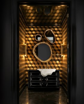 Bathroom | gothic bathroom in modern classic style with Petra dark vanity cabinet for storage, Halo set of wall mirrors, Cyrus wall lamp, geometric yellow wallpaper, and marble flooring