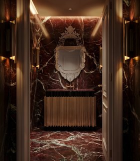 Bathroom | deep red marble bathroom in modern classic style with Veneto rococo wall mirror, Symphony gold washbasin and cabinet for storage, Cyrus dark wall lamp, and marble flooring