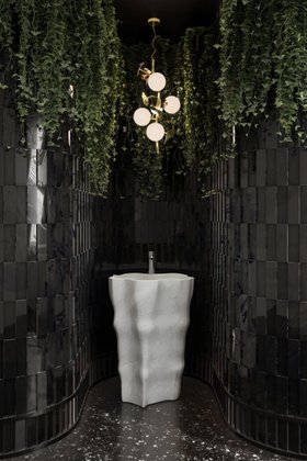 Bathroom | dark paint bathroom with Eden marble freestanding, Hera gold pendant lamp, some greenery, and marble flooring
