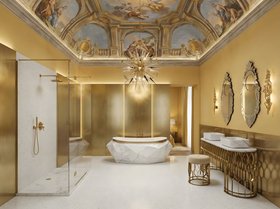 Bathroom | yellow and gold paint bathroom in modern classic style with Diamond white marble bathtub, Mecca washbasin, Mecca stool, Outburst chandelier, Veneto rococo wall mirror, Cay wall lamp, shower, ceiling wallpaper, and marble flooring