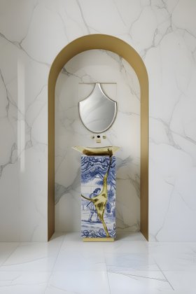 Bathroom | white marble bathroom with Lapiaz freestanding in portuguese tile, gold vessel sink, and Koi curvy wall mirror