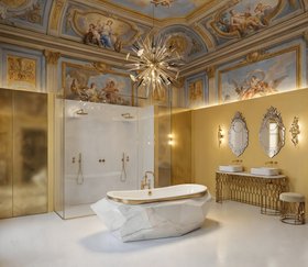 Bathroom | yellow and gold paint bathroom in modern classic style with Diamond white marble bathtub, Mecca washbasin, Mecca stool, Outburst chandelier, Veneto rococo wall mirror, Cay wall lamp, shower, ceiling wallpaper, and marble flooring