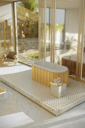 Bathroom | marble bathroom in gold details with Symphony bathtub, Stonehenge side table, Ethereal armchair, wall mirror, and marble flooring