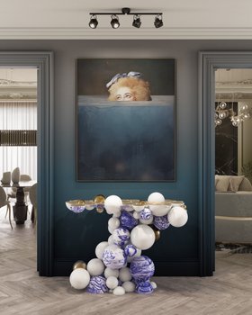 Entryway | deep blue paint hallway in modern classic style with Newton white console in portuguese tile, wall art, and brown wood flooring