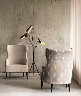 Living Room | mid century modern reading corner with Iguazu curvy striped armchair in black and white tones, Jackson retro dark floor lamp, and stone wall