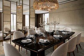 An Upscale Apartment in India | modern classic dining room with Beyond dark dining table, Imperfectio velvet dining chair, Trinity gold chandelier, Altura set of mirrors, tablescape, and candles