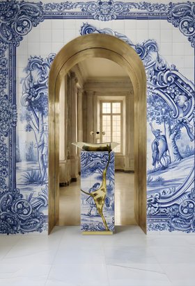 Bathroom | luxury bathroom in portuguese tile with Lapiaz pedestal sink, Lapiaz gold vessel sink, wallpaper, floor mirror, and marble flooring