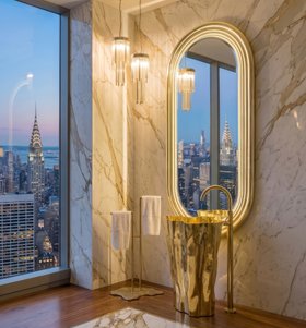 Bathroom | luxury bathroom in marble finishes with Eden gold freestanding, Eden towel rack, Pharo crystal suspension lamp, Colosseum wall mirror, and brown wood flooring