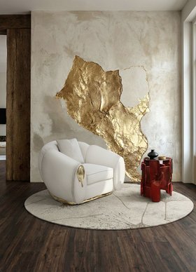 Living Room | autumn/winter reading corner in cosy elegant style with Soleil white armchair, Goroka deep red side table, Macushi neutral rug, textured gold wall art, cushion, and brown wood flooring