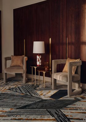 Living Room | cosy elegant reading corner in modern classic style with Rukay curvy grey armchair, Luray side table, Amik table lamp, Xisto neutral rug, cushion, and brown wood cabinet for storage