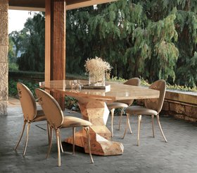 Outdoor | porch dining area in neutral tones with Bonsai poplar root dining table, Soleil cream dining chair, vase, and stone flooring