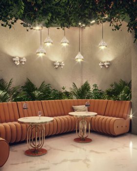 Living Room | spring/summer reading corner in nature-inspired style with Sophia retro orange sofa, Hanna gold coffee table, Turner pendant lamp, some greenery, and marble flooring
