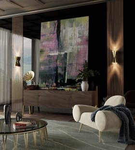 Living Room | cosy neutral reading corner in retro style with Apollo white single sofa, Newson glass center table, Piazzola gold wall lamp, Vittorio brown wood sideboard for storage, Warao wavy rug, mantle, and wall art