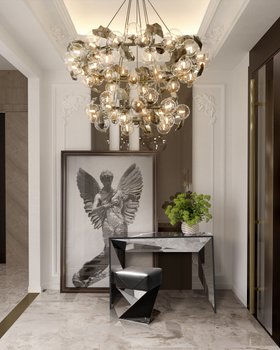 Entryway | modern classic hallway with Linear dark console table, Pentagon black stool, Hera gold suspension lamp, wall art, vase, and marble flooring