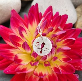 Bird in a tree pendant in textured sterling silver