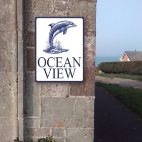 Dolphin house or cottage sign