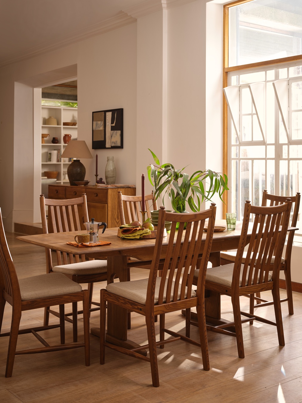 ercol Windsor Medium Extending Dining Table with Penn Classic Dining Chairs in a Vintage finish.