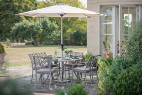 Bramblecrest RHS Bridgewater Stone Cast Aluminium 6 Seat Oval Dining Set with Parasol & Base