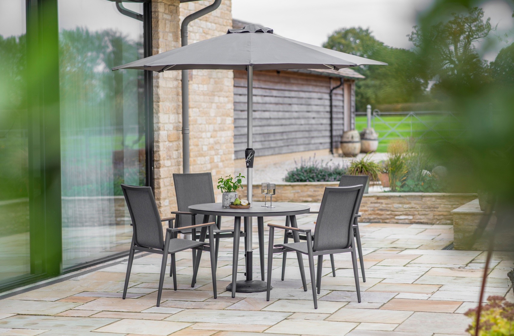 Bramblecrest Sofia 110cm Round Table with 4 Armchairs, Parasol & Base - Anthracite