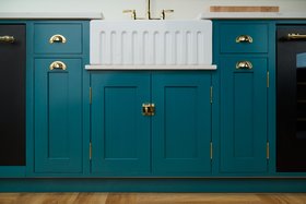 Blue Kitchen With Brass Handles And Fluted Sink
