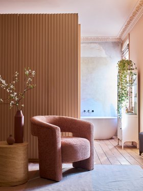 DFS Essie Accent Chair Essie Body Blush, Dwell Eos Side Table in Travertine, available exclusively at DFS