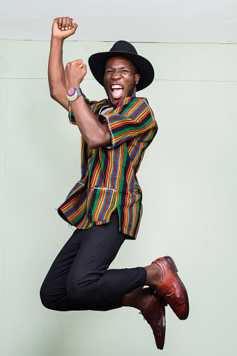 ANKARA MAN HAPPILY JUMP PORTRAITS INDOORS ON LOCATION