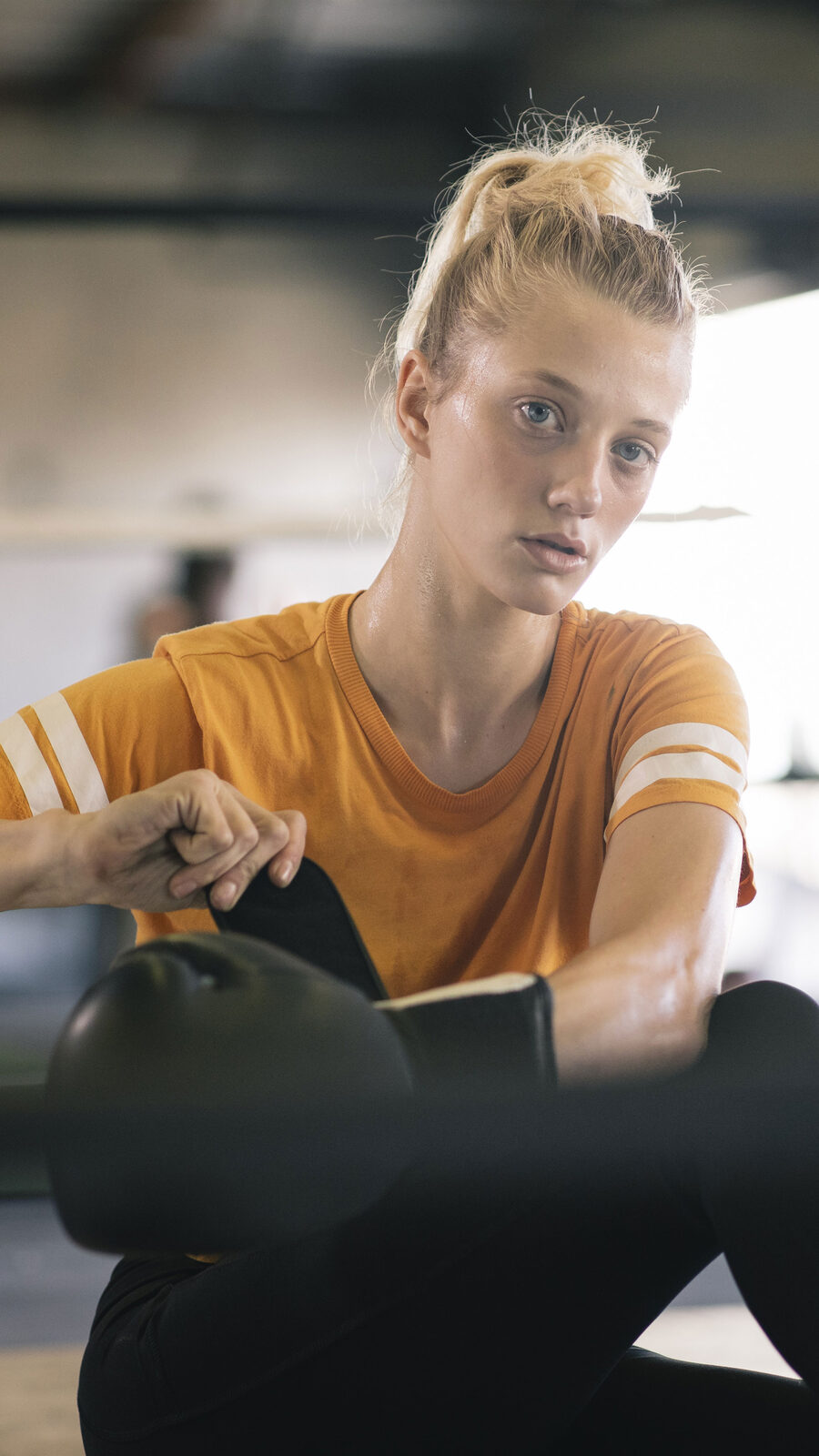 Woman in a yellow top training indoors
