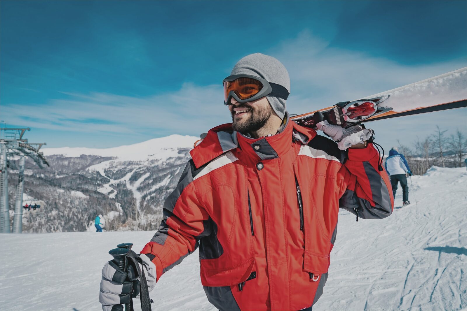 Skier carrying skis on a mountain