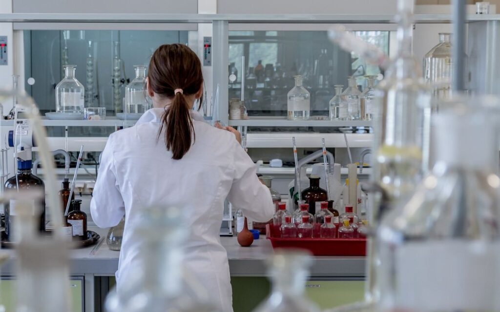 Lady in a laboratory in a lab coat doing clinical trial