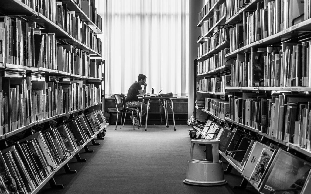 a student studying in a university library in readiness for a career in life sciences