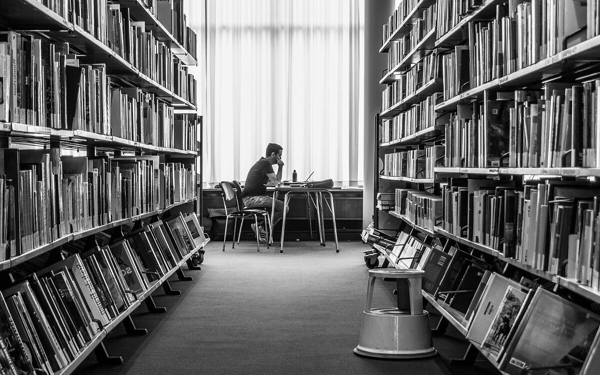 a student studying in a university library in readiness for a career in life sciences