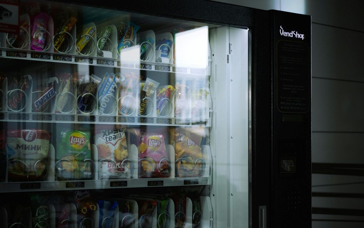 Vending machine stocked with sugary drinks and processed snacks.