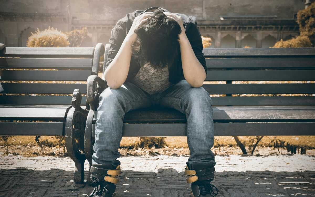 Depression young man on bench with depression