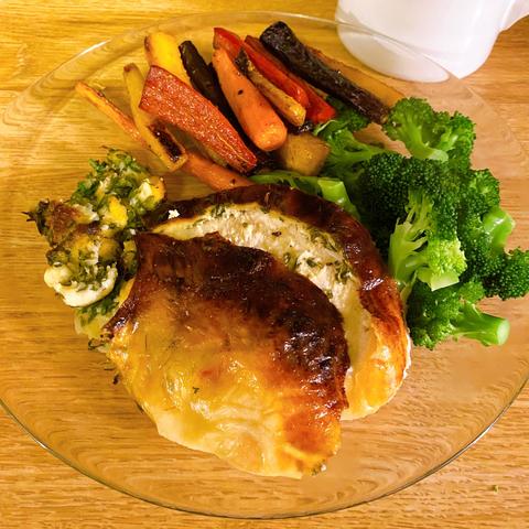 Two slices of breast with skin on a plate, with a couple spoonfuls of the stuffing, a pile of roasted rainbow carrots, and some steamed broccoli

What's that lurking at the edge of the photo? Is it a pitcher of gravy?