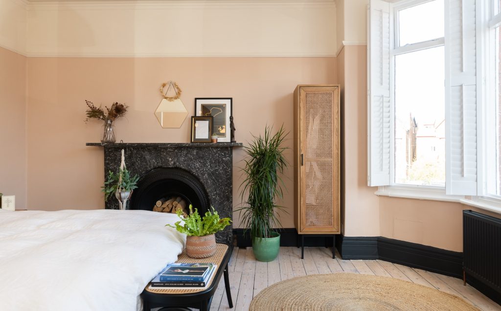Bedroom with peach coloured walls and original fireplace at a multi-backdrop shoot location