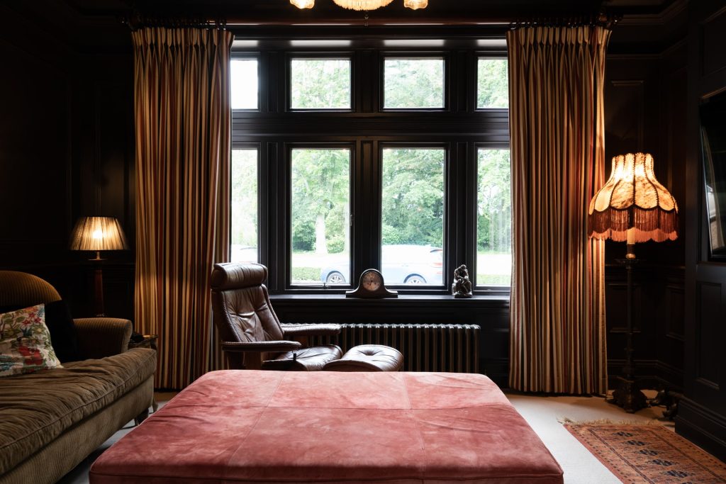 Armchair in front of a bay window in an opulent living room at a multi-backdrop location.